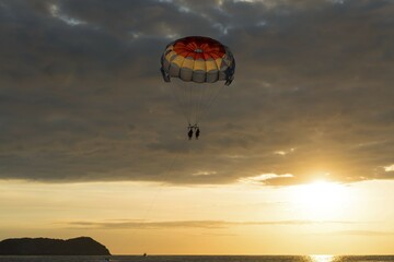 Parasailing at sunset over the sea, Playa Espadilla, National Park Manuel Antonio, Costa Rica, Central America
