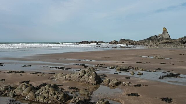 Gentle waves at Hartland Quay Devon low tide