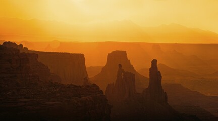 Silhouette, rocks in the morning light, behind the La Sal Mountains, Canyonlands National Park,...