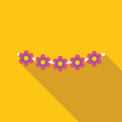Flower garland is laying on a vibrant yellow background with a long shadow