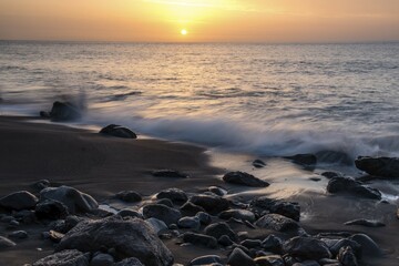 Obraz premium Black sandy beach with stones, Playa del Ingles at sunset, Valle Gran Rey, La Gomera, Canary Islands, Spain, Europe