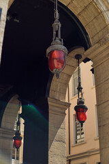 Red lamps hanging from ceiling in Lyon city centre, France