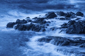 Fototapeta premium Washed over rocks in the water, waves, long exposure, La Gomera, Canary Island, Spain, Europe
