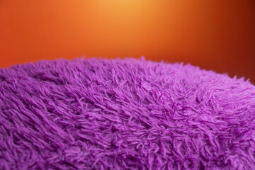 a purple fuzzy blanket with a bright orange background.