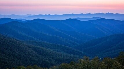 Naklejka premium Blue Ridge Mountains at sunset, with a soft pink sky and layers of hills.