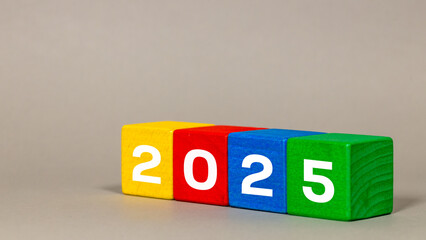 2024 to 2025, White numbers on joyfully colored blocks, Merry Christmas and a Happy New Year, gray background
