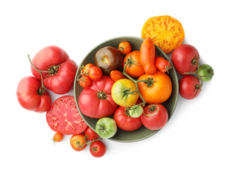 Different ripe tomatoes in bowl isolated on white, top view