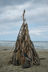 Driftwood teepee structure on Mendihuaca beach, Colombia