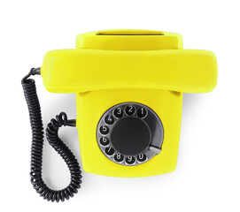Old yellow telephone with rotary dial isolated on white, top view