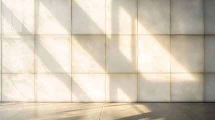 Obraz premium Sunlight streams through large windows onto a white tiled wall.