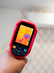 Checking freon route. A specialist conducts a thermal imaging examination inside the building. Inspection of the walls of the room to eliminate deficiencies and insulate problem areas