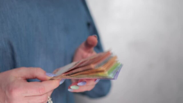Female hands holding paper bills Belarusian rubles