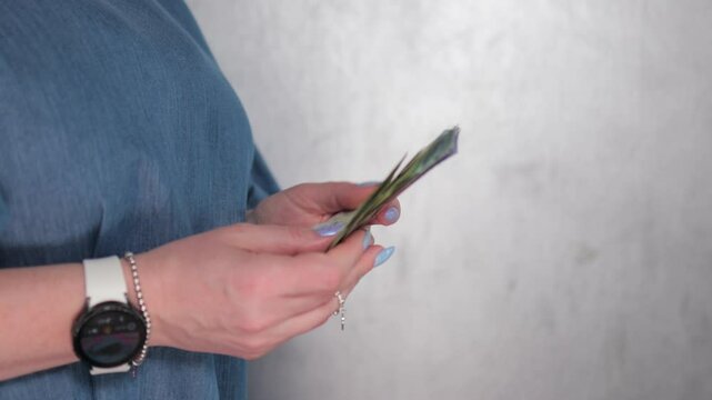 Female hands holding paper bills Belarusian rubles
