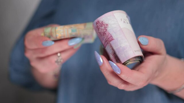 Female hands holding paper bills Belarusian rubles