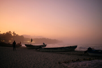 Mendihuaca beach at sunset with foggy air and boats, Colombia
