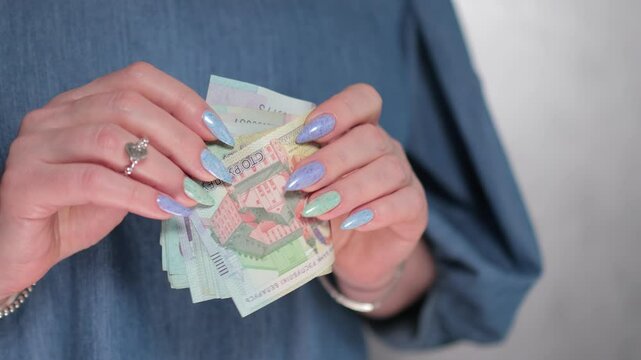 Female hands holding paper bills Belarusian rubles
