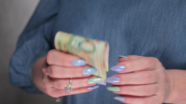 Female hands holding paper bills Belarusian rubles