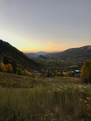 Sunset in the mountains with a view of city