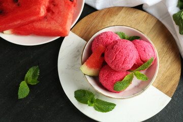 Scoops of tasty watermelon sorbet with mint and fresh fruit on grey textured table, flat lay