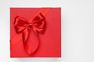 Gift box with bow on light grey background, top view. Space for text