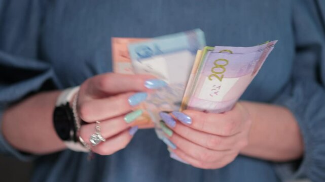 Female hands holding paper bills Belarusian rubles