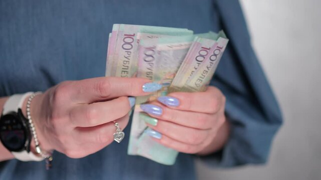 Female hands holding paper bills Belarusian rubles