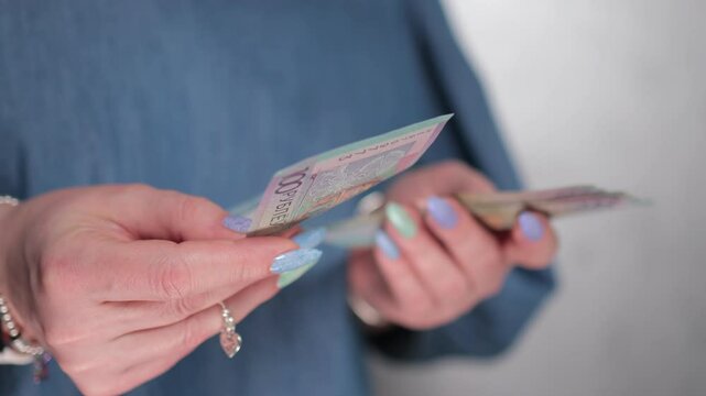 Female hands holding paper bills Belarusian rubles