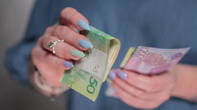 Female hands holding paper bills Belarusian rubles