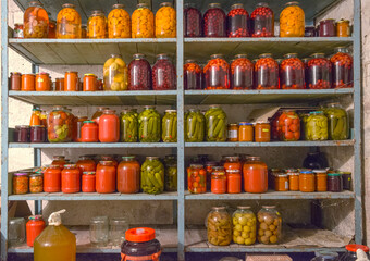 Close-up shelving with home-canned provisions in home cellar.
