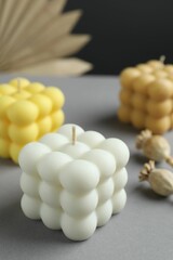Beautiful bubble candles and decor on grey table, closeup