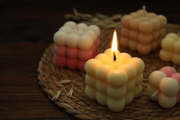Different stylish bubble candles on wooden table, closeup. Space for text