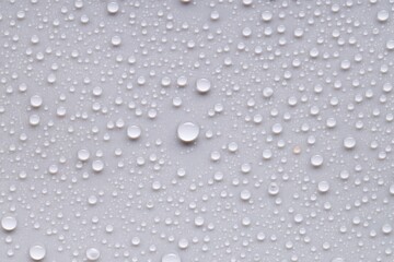 Water drops on light gray background, top view