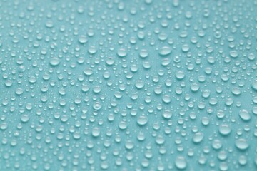 Water drops on turquoise background, above view
