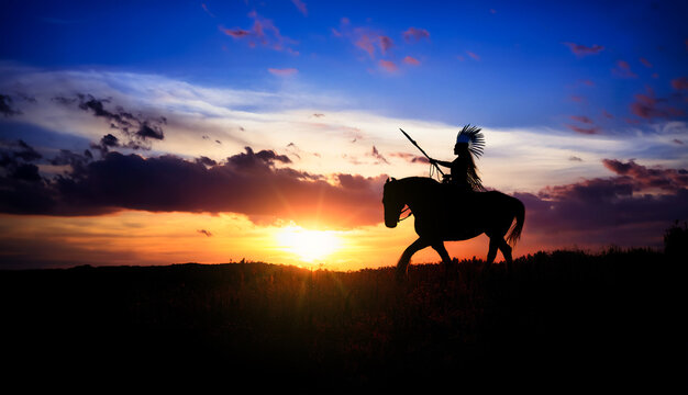 silhouette of an American Indian on horseback at sunset