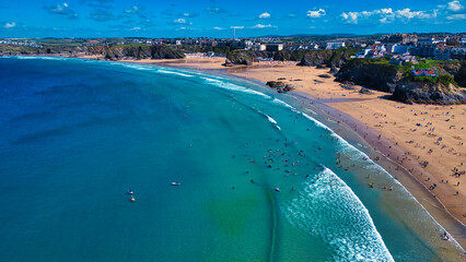 Fototapeta premium Aerial View of a Beautiful Beach with Surfers at Towan Beach, Newquay, Cornwall.
