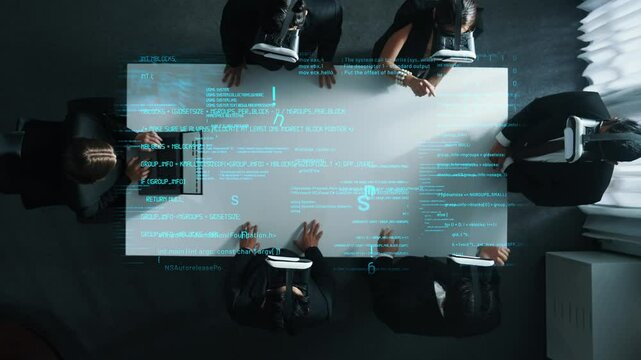 Top down aerial view of professional business team wear vr headset while stands around coding engineering prompt holographic and using hand gestures to manipulate the data from the manager laptop.