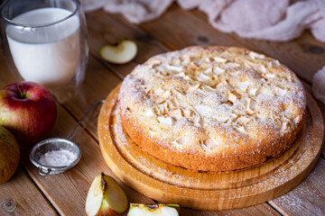 Sweet apple pie on a wooden table. Apple pie for dessert for breakfast. Close-up.