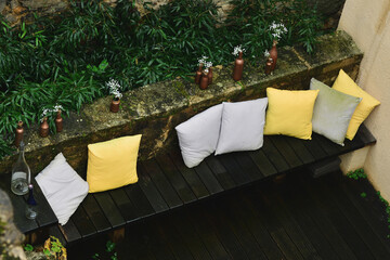 Terrace design with sofa, pillows and flowers. Patio. Garden.