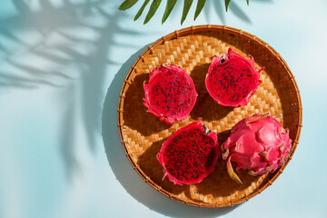 dragon fruit, also known as pitaya, cut open pink magenta-colored flesh with tiny black seeds, tropical fruits
