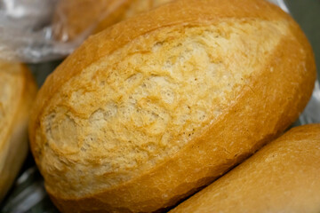 Freshly baked bread rolls with a golden crust resting together. Perfect for bakery and food-related projects.