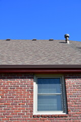Shingles on a Roof on a Brick Building