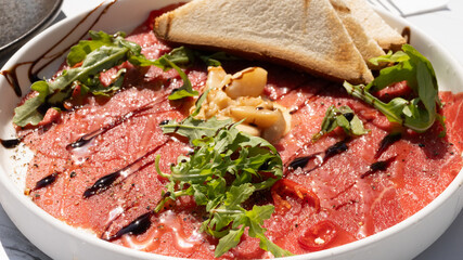 Chilled Beef carpaccio cold on white plate