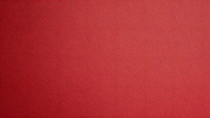 Fototapeta premium Sheet of red paper texture background, showcasing a smooth, vibrant red surface with subtle tonal variations