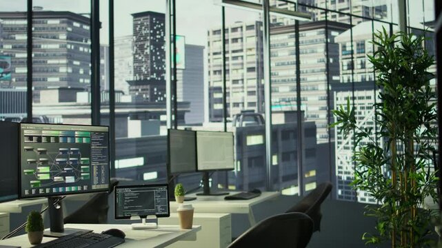 Programming language on digital devices screen in empty IT department office used for app development. Panning shot of tablet and PC left open on desk in tech startup company workspace with nobody in