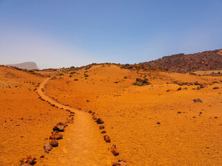 spot in Tenerife with many red rocks and beautiful mountain landscape background