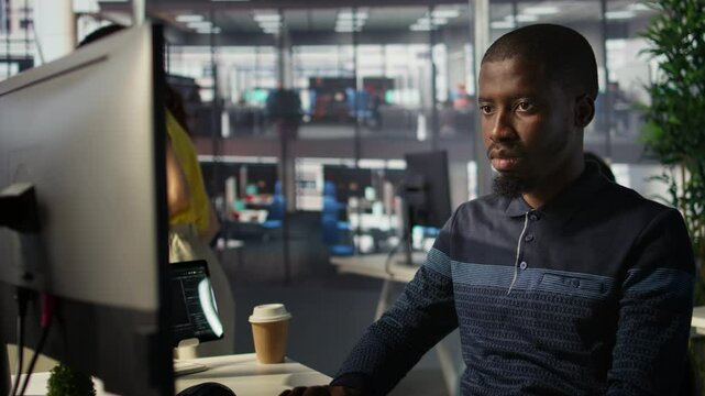 Upbeat software engineer utilizing cloud computing resources to train and deploy large scale machine learning models. Jolly man monitoring company systems, ensuring their reliability, camera B