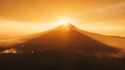 Sunrise over Mount Fuji, Japan with the sun rising behind one of its peaks