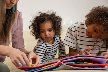 Family bonding time with children enjoying art and stories in colorful book, engaging creativity and imagination concept © Silga