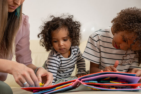 Family bonding time with children enjoying art and stories in colorful book, engaging creativity and imagination concept