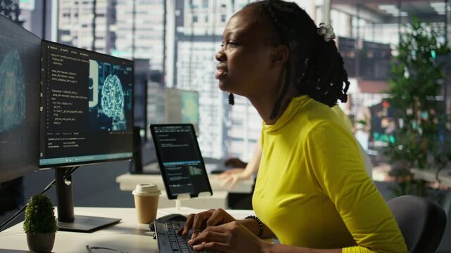 Tired african american programmer having strained eyesight from overworking in office. Close up of woman at work removing eyeglasses to rub eyes, looking at PC screen for too long, camera B
